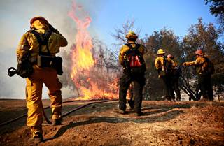 Firefighters battle a blaze at the Salvation Army Camp on November 10, 2018 in Malibu, CA. Firefighters battle a blaze at the Salvation Army Camp on November 10, 2018 in Malibu, CA.